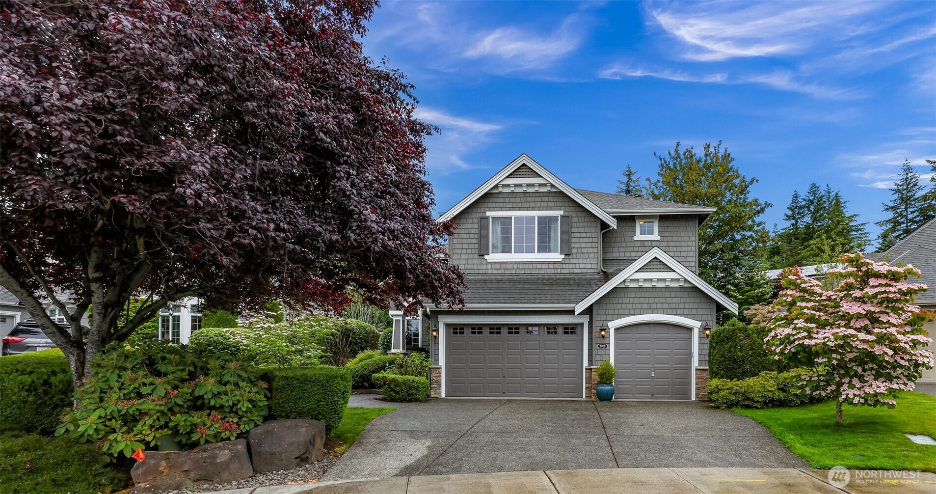 2029 240th Place Southeast Bothell, WA 98021 - Photo 1 of 39 a front view of a house with a garden