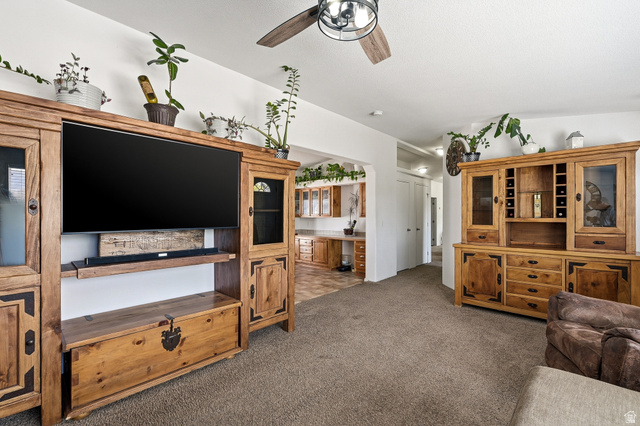 1637 East Midvalley Road Enoch, UT 84721 - Photo 5 of 48 Living area with dark carpet and ceiling fan