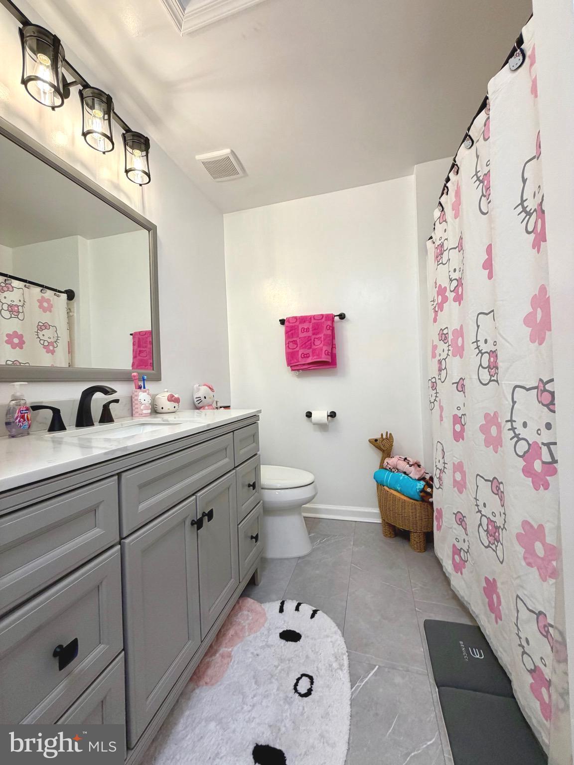 7108 Wheeling Way Gainesville, VA 20155 - Photo 32 of 45 a spacious bathroom with a sink mirror vanity and toilet