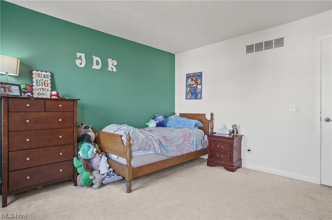 4169 Whitestone Road Kent, OH 44240 - Photo 23 of 33 Bedroom with light colored carpet and a textured ceiling