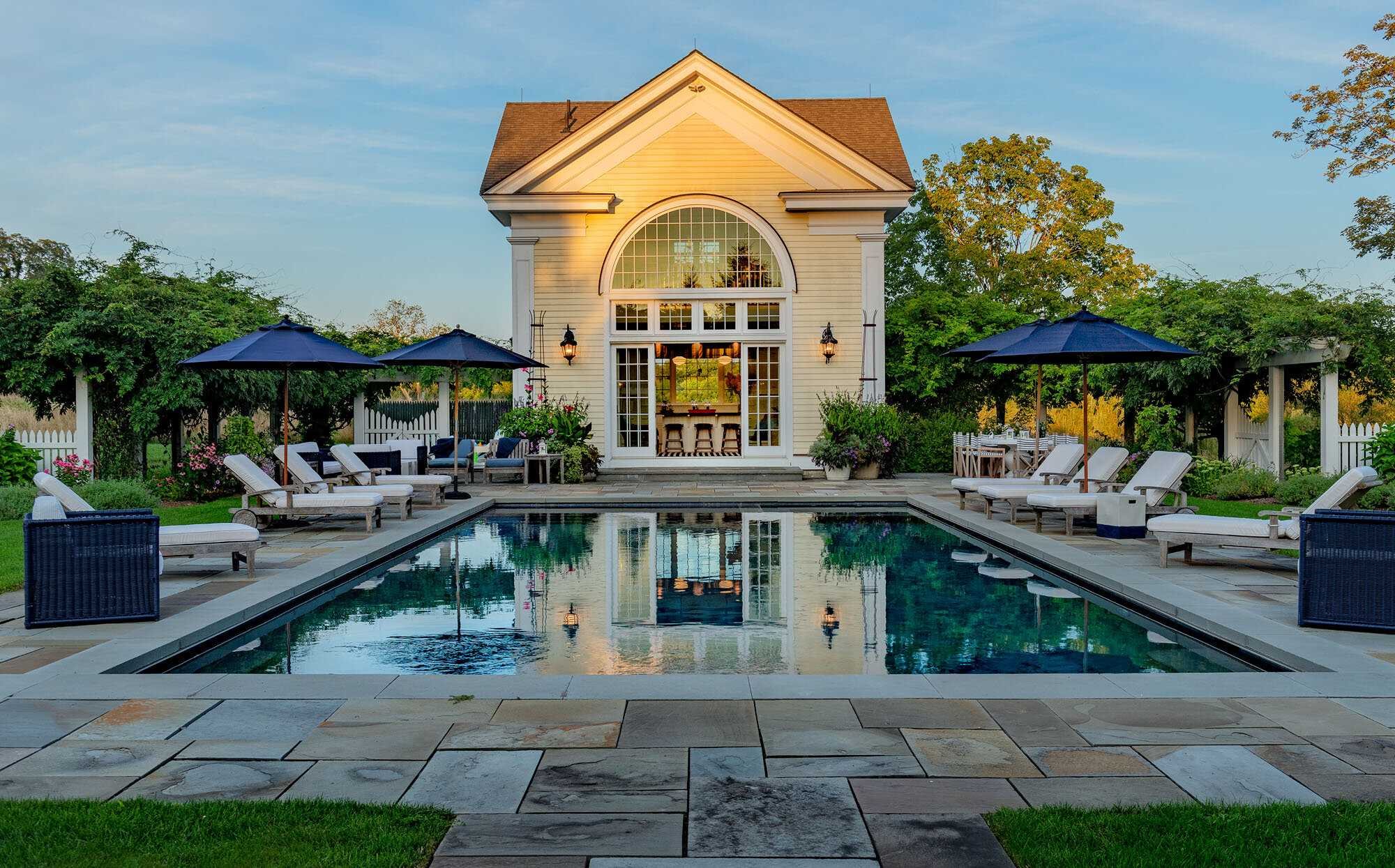 140 Sunset Trail Clinton, NY 12514 - Photo 22 of 30 a view of a swimming pool with a bench and tables under an umbrella