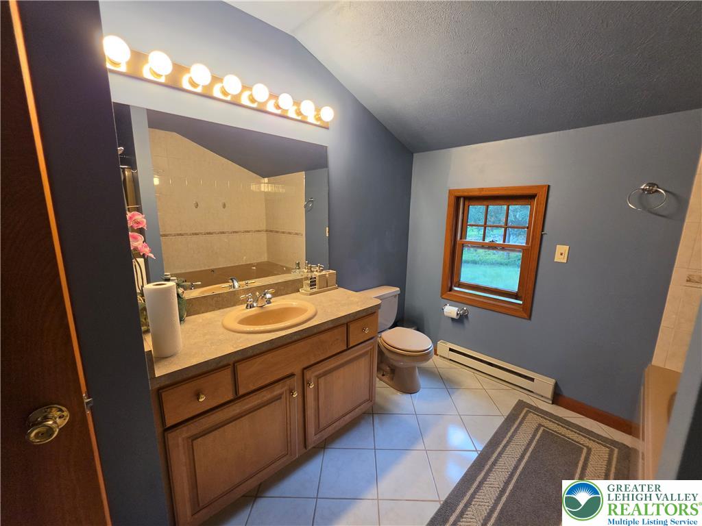 211 Murphy Circle Bushkill, PA 18324 - Photo 12 of 28 A well-appointed bathroom features a spacious vanity and tiled flooring, perfect for a relaxing retreat.