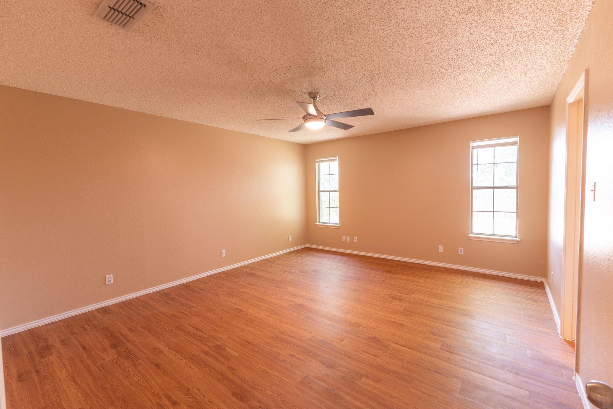 6115 8th Street Lubbock, TX 79416 - Photo 12 of 18 wooden floor in an empty room with a window