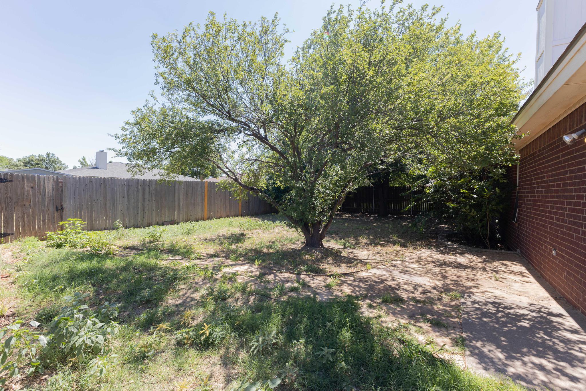 6115 8th Street Lubbock, TX 79416 - Photo 18 of 18 a backyard of a house with lots of green space