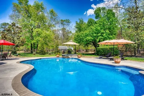 a view of a backyard with sitting area