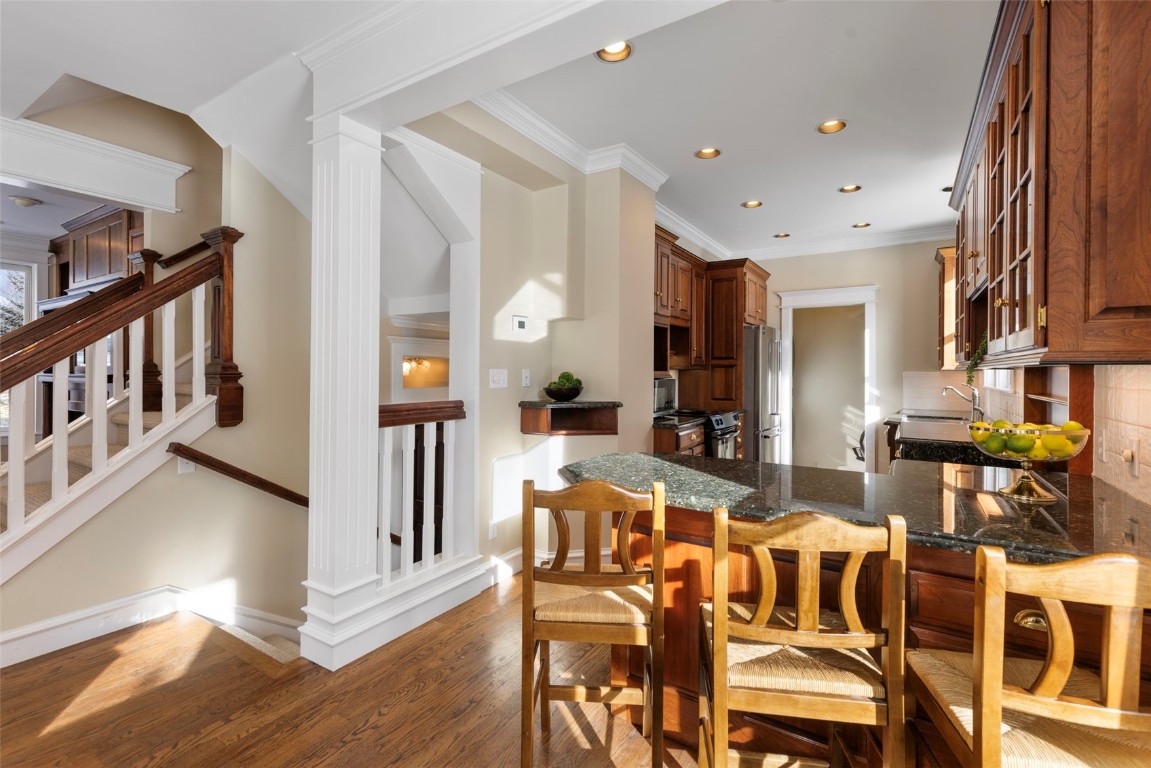 192 Wellington Road Breckenridge, CO 80424 - Photo 11 of 50 Kitchen featuring a kitchen breakfast bar, ornamental molding, light wood-style flooring, high end refrigerator, and a peninsula