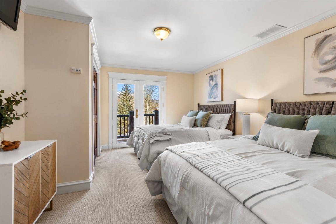 192 Wellington Road Breckenridge, CO 80424 - Photo 15 of 50 Bedroom with access to exterior, carpet flooring, ornamental molding, and french doors