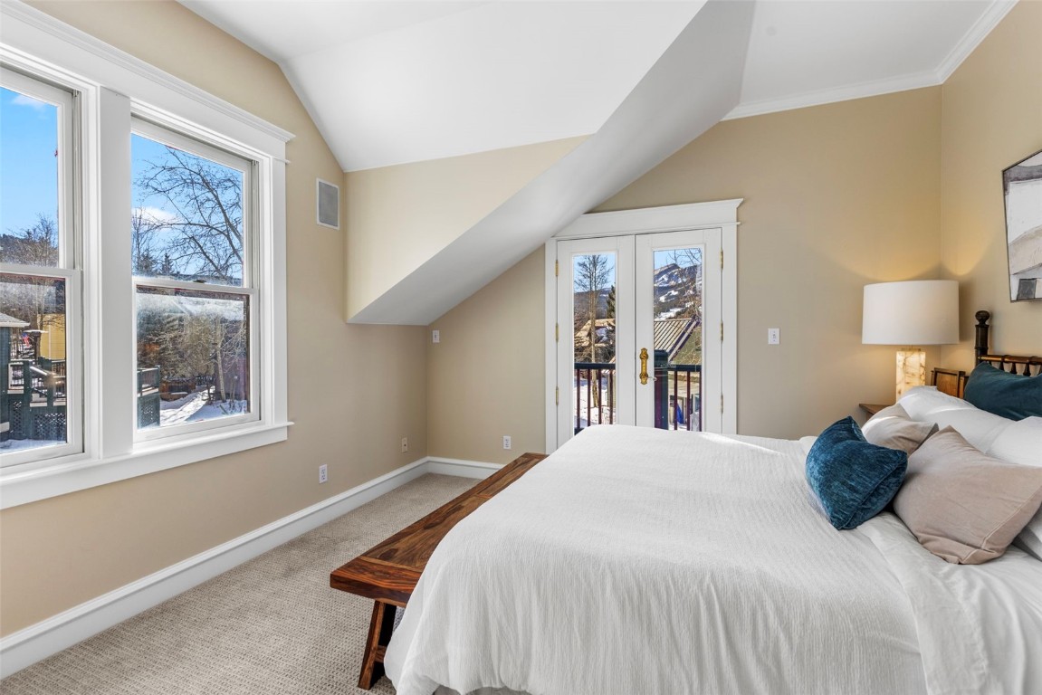 192 Wellington Road Breckenridge, CO 80424 - Photo 23 of 50 Primary bedroom with attached deck and large bathroom featuring french doors, access to outside, and vaulted ceiling