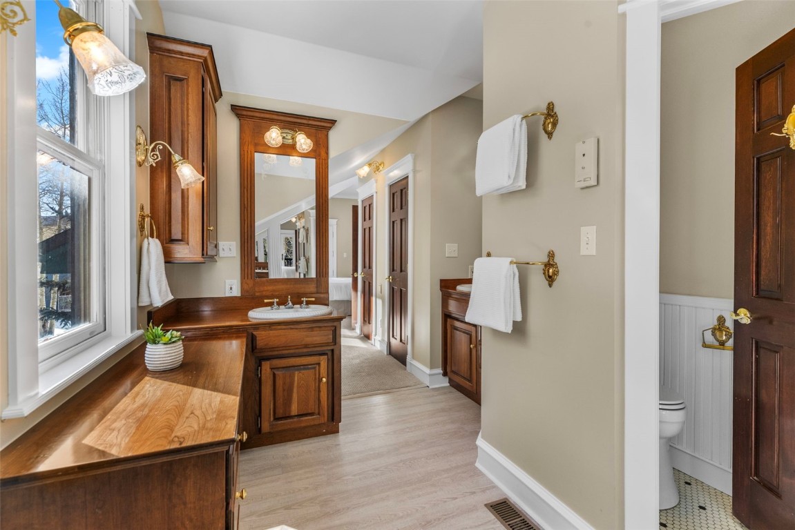 192 Wellington Road Breckenridge, CO 80424 - Photo 29 of 50 Bathroom with vanity, a wainscoted wall, and light wood-type flooring