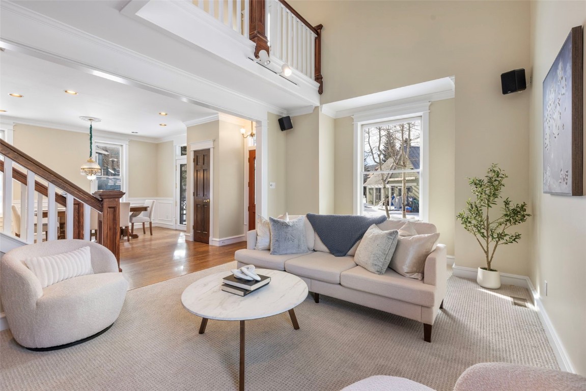 192 Wellington Road Breckenridge, CO 80424 - Photo 5 of 50 Living room featuring crown molding, wainscoting, stairway, and a decorative wall