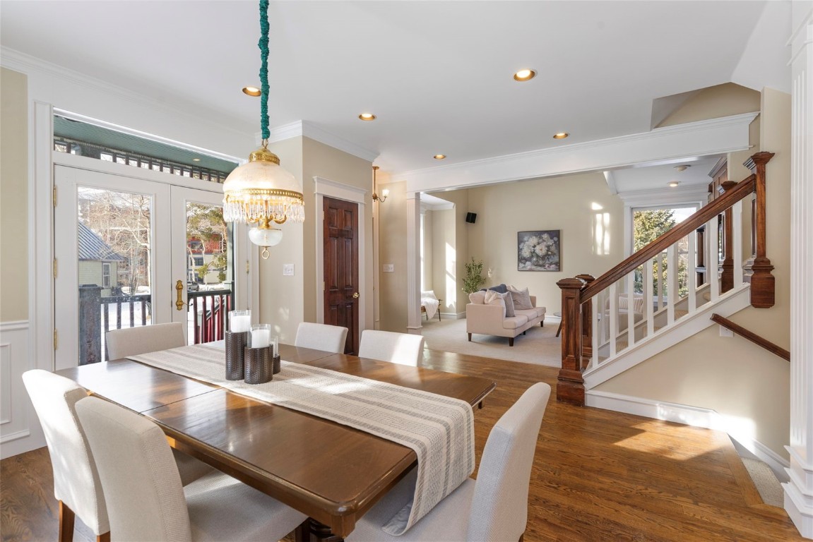 192 Wellington Road Breckenridge, CO 80424 - Photo 9 of 50 Dining room featuring dark wood finished floors, crown molding, stairway, healthy amount of natural light, and recessed lighting