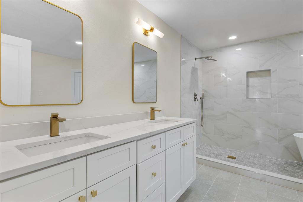 2816 Quail Ridge Drive Carrollton, TX 75006 - Photo 14 of 33 Bathroom with a marble finish shower, double vanity, a soaking tub, recessed lighting, and light tile patterned floors