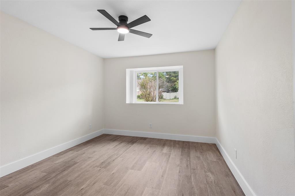 2816 Quail Ridge Drive Carrollton, TX 75006 - Photo 19 of 33 Empty room with light wood-type flooring and ceiling fan