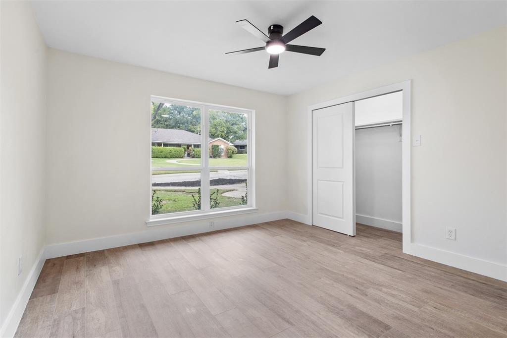 2816 Quail Ridge Drive Carrollton, TX 75006 - Photo 20 of 33 Unfurnished bedroom with ceiling fan, light wood-type flooring, and a closet