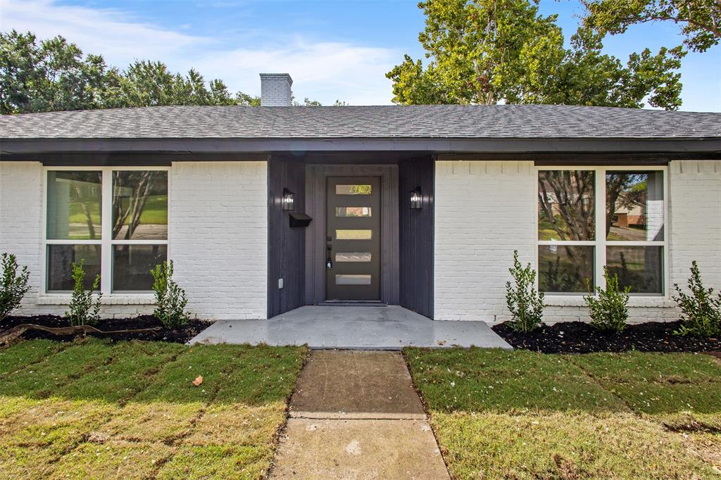 2816 Quail Ridge Drive Carrollton, TX 75006 - Photo 2 of 33 View of exterior entry with a lawn, brick siding, a chimney, and roof with shingles