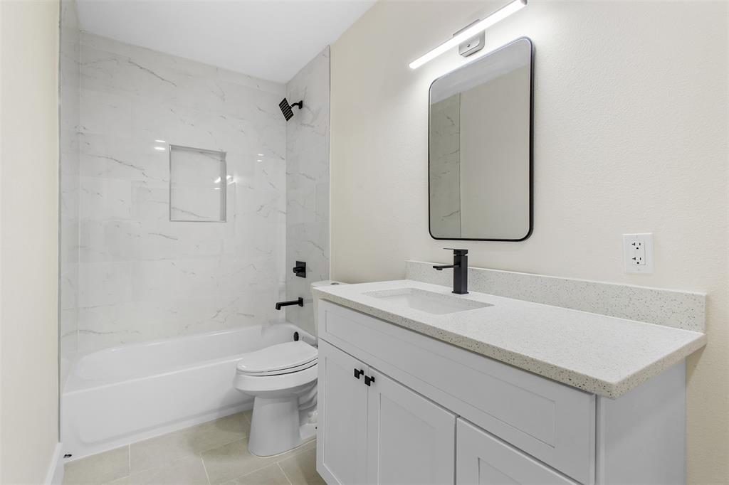 2816 Quail Ridge Drive Carrollton, TX 75006 - Photo 21 of 33 Full bathroom featuring shower / tub combination, vanity, and light tile patterned floors