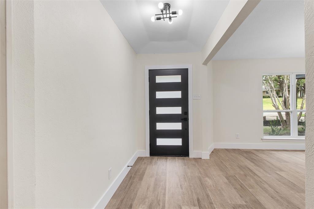2816 Quail Ridge Drive Carrollton, TX 75006 - Photo 27 of 33 Entrance foyer with light wood-style floors and baseboards