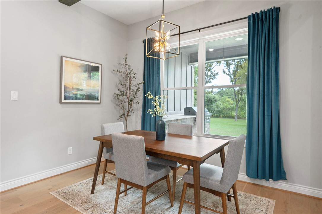 13291 Hopes Creek Road College Station, TX 77845 - Photo 10 of 45 Dining room with light wood-type flooring and a chandelier