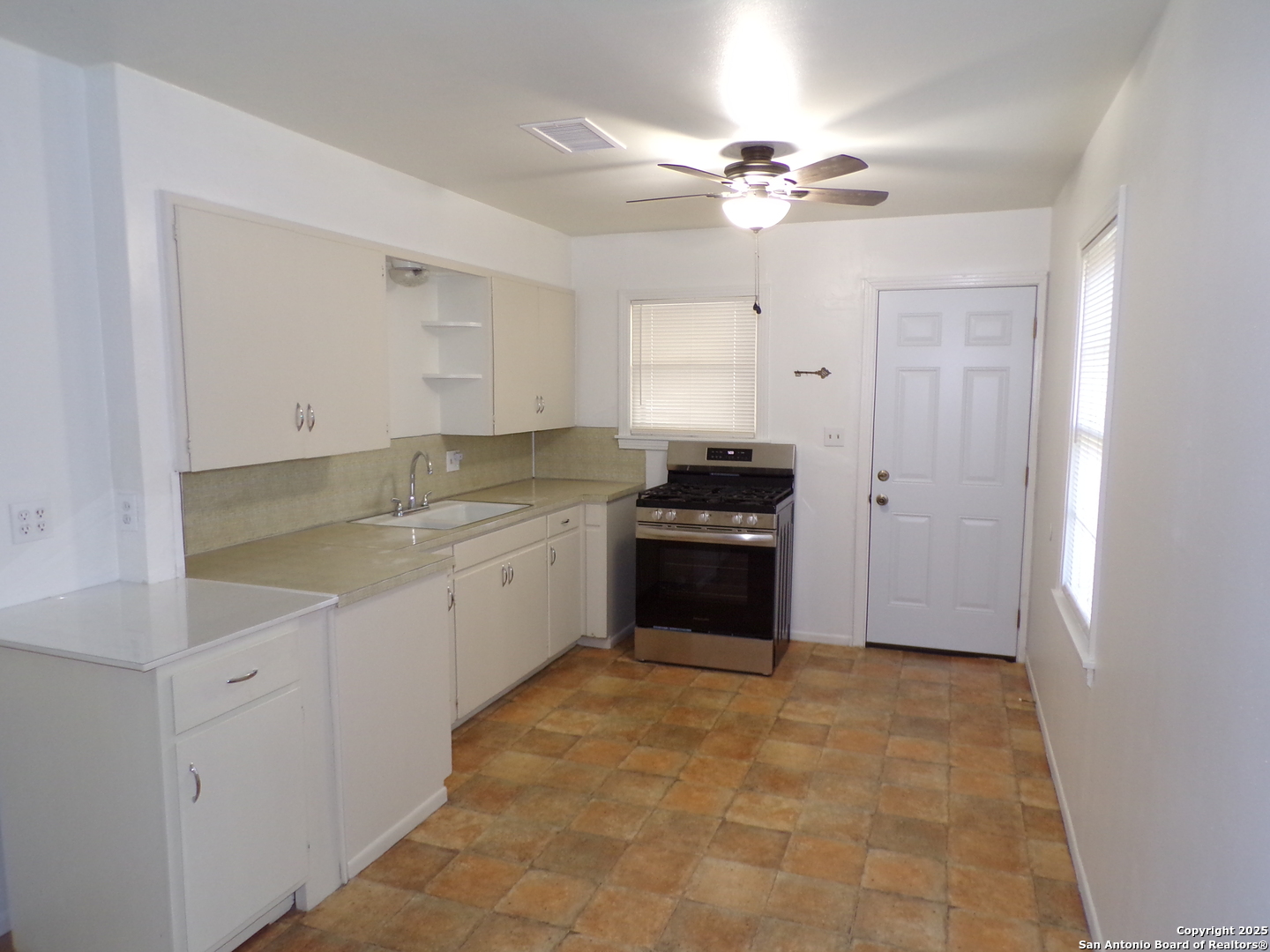 409 Bohme Street Uvalde, TX 78801 - Photo 2 of 9 a large white kitchen with a sink and cabinets