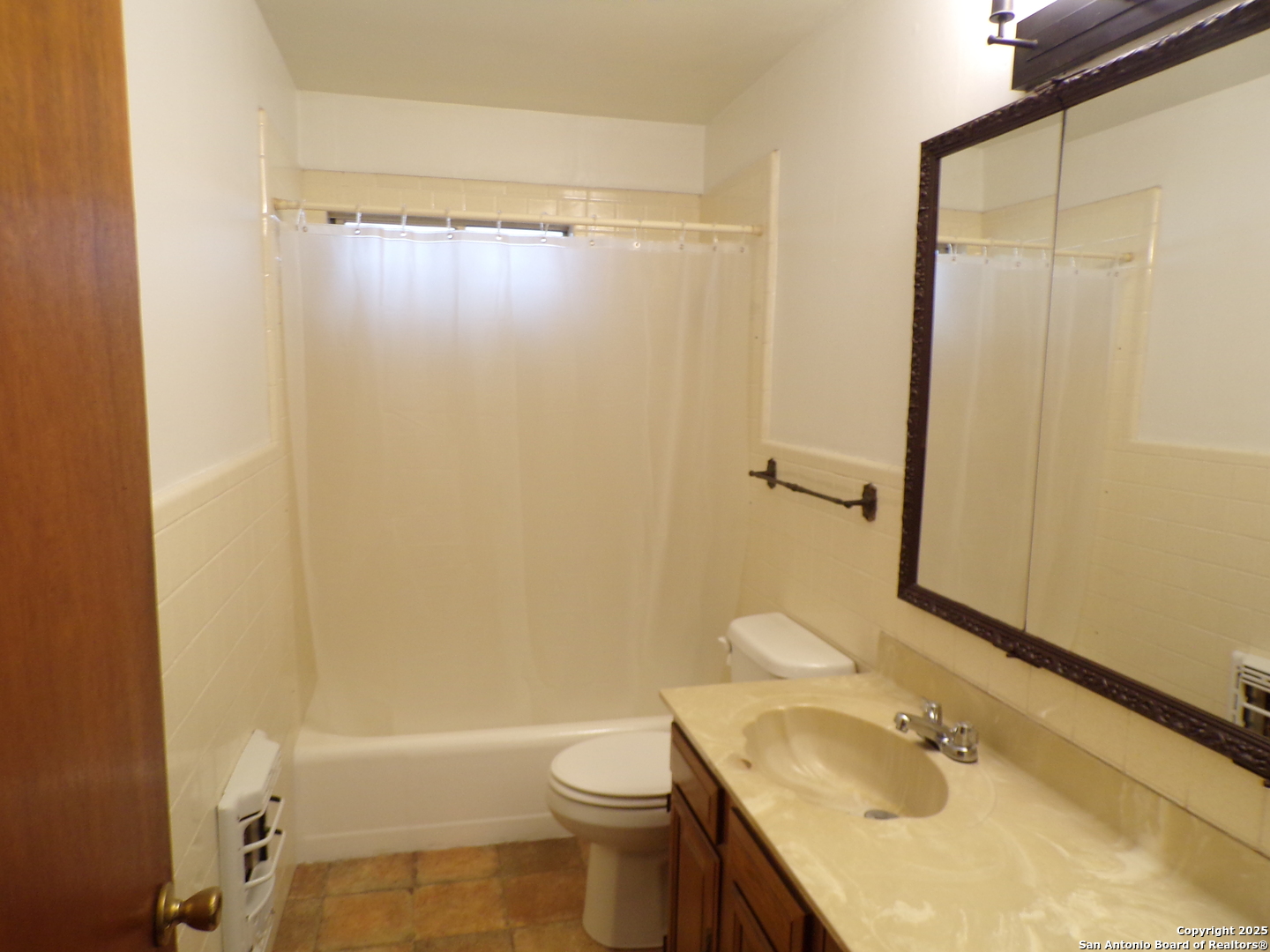 409 Bohme Street Uvalde, TX 78801 - Photo 4 of 9 a bathroom with a granite countertop sink toilet and shower