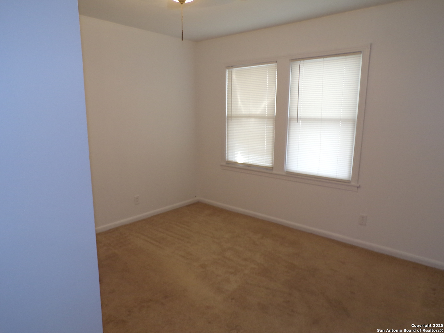 409 Bohme Street Uvalde, TX 78801 - Photo 5 of 9 an empty room with a window