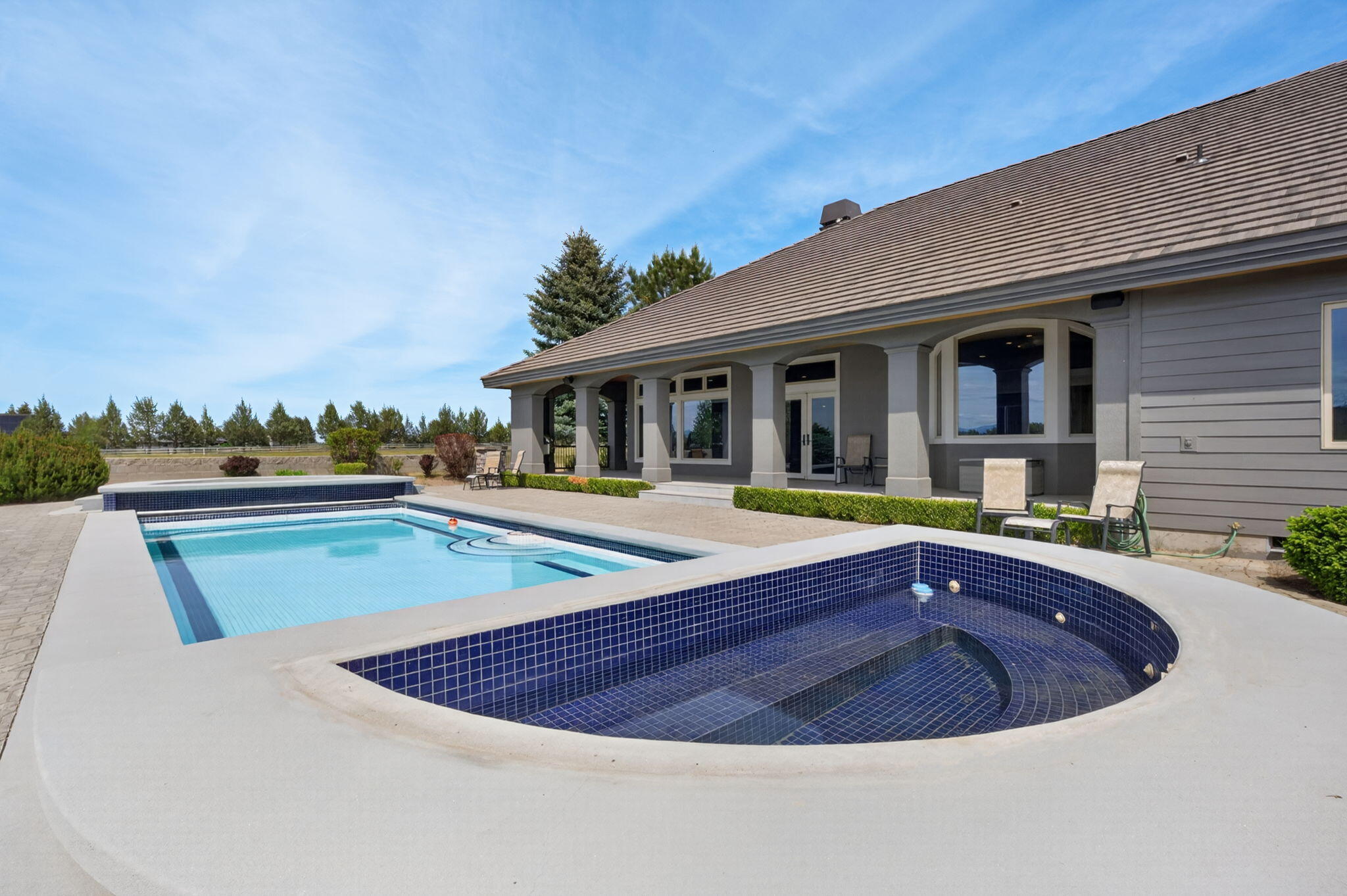 20180 Winston Loop Bend, OR 97703 - Photo 53 of 59 a view of a house with pool and chairs