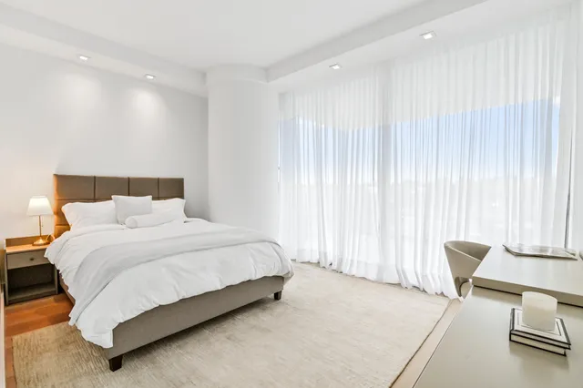 a bedroom with a bed and chair