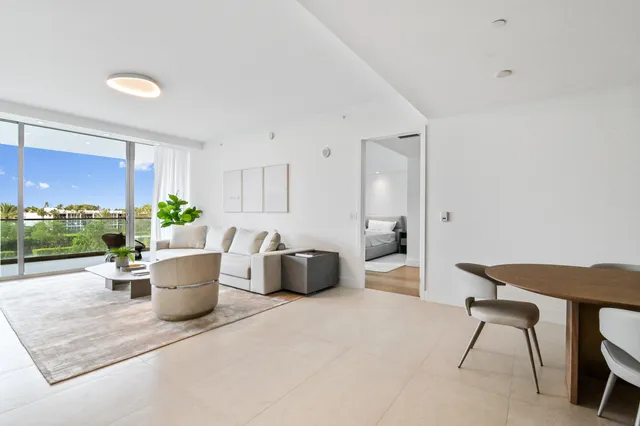 a living room with a couch and a potted plant