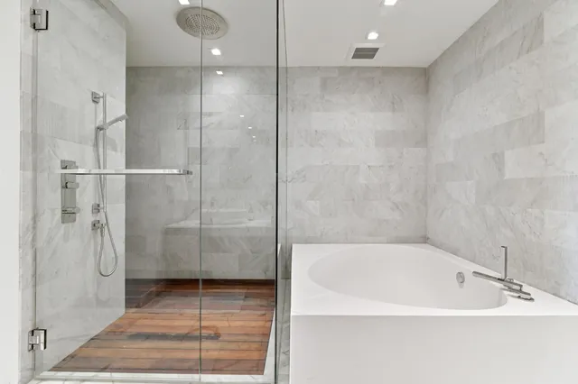 a bathroom with a bathtub and a shower