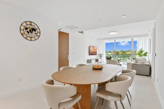 a view of a dining room with furniture and a potted plant