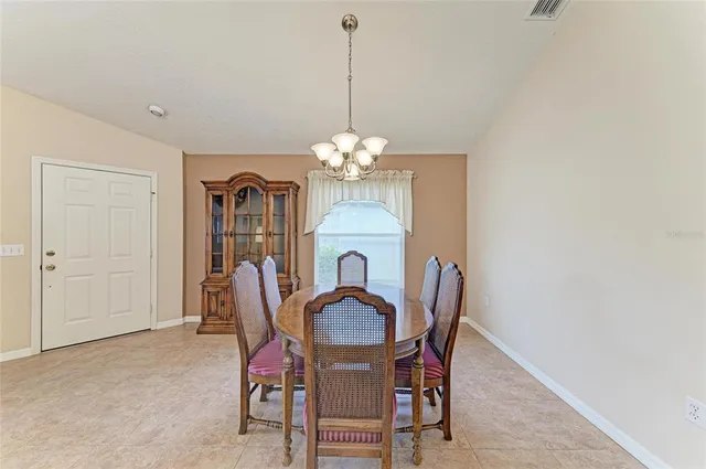 a dining room with furniture and chandelier