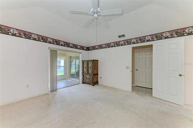 a view of empty room with ceiling fan