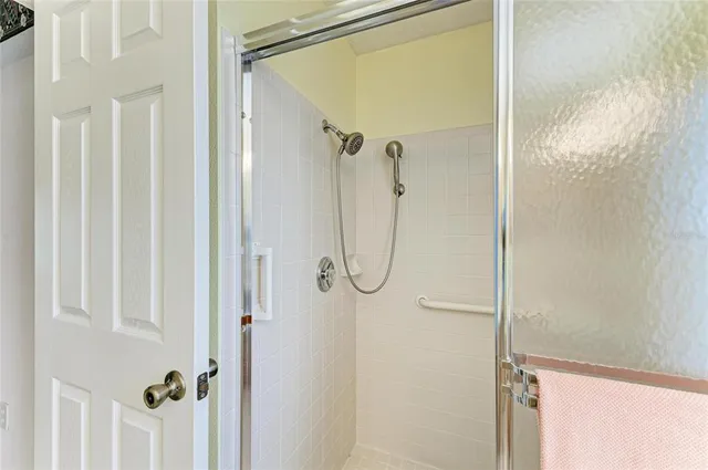 a bathroom with a glass shower door