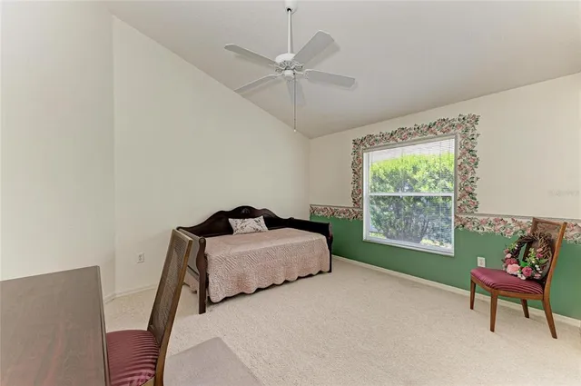 a bedroom with a bed and a chair