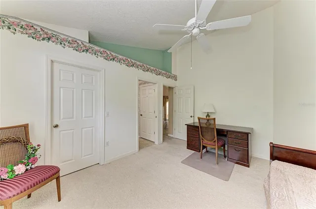 a view of a workspace with furniture and a window