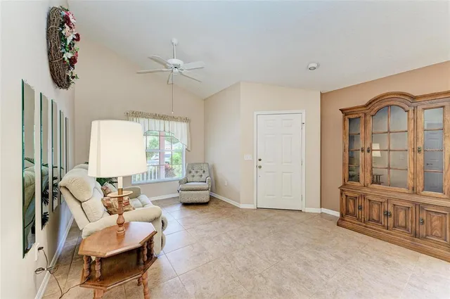 a living room with furniture and large windows