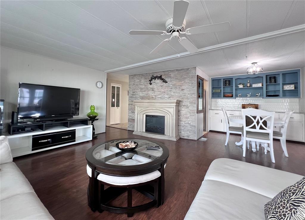 1100 South Belcher Road, Unit 772 Largo, FL 33771 - Photo 18 of 84 a living room with furniture a flat screen tv and a fireplace