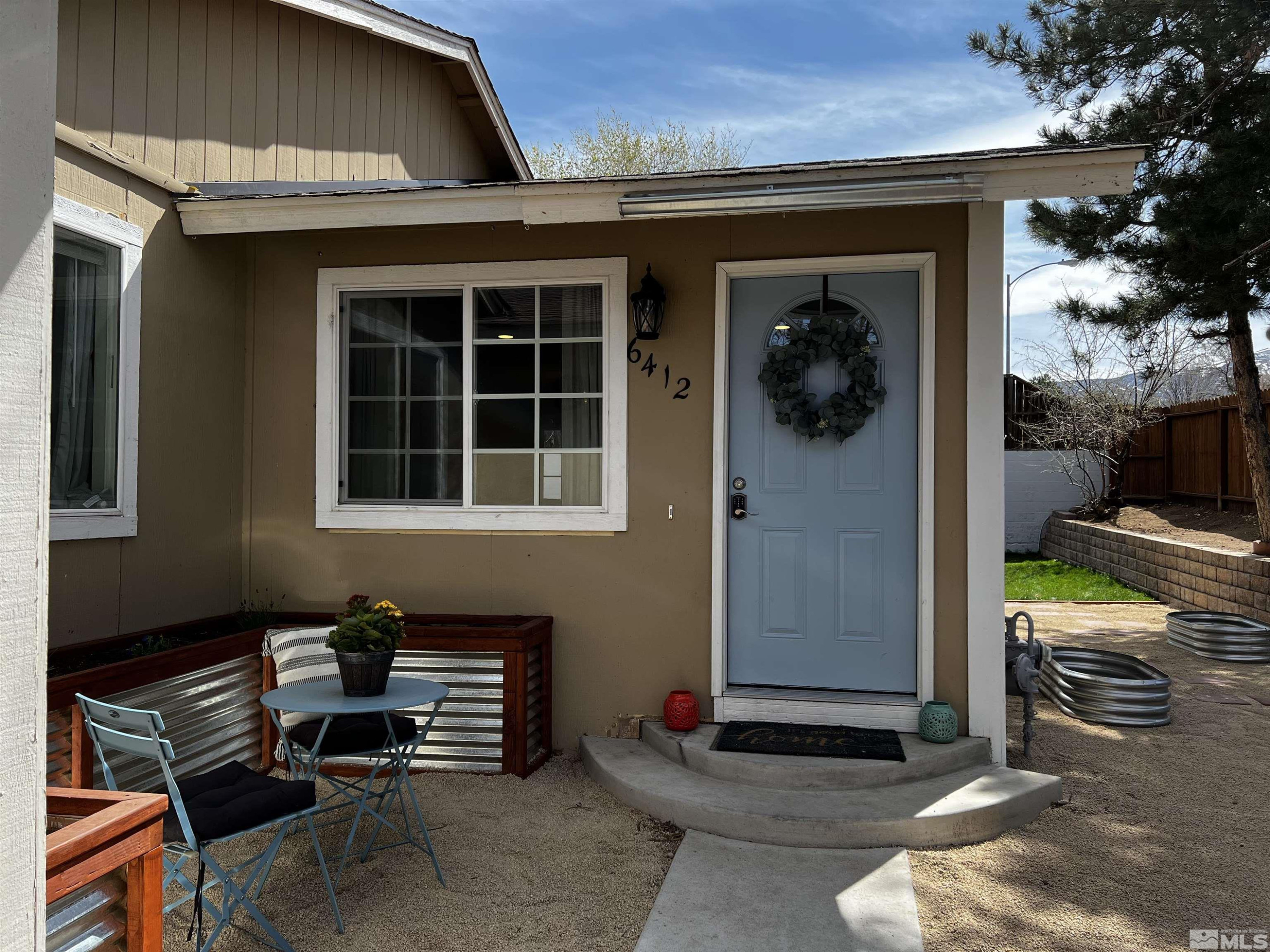 6412 Flower Street Reno, NV 89506 - Photo 1 of 38 a front view of a house with a porch