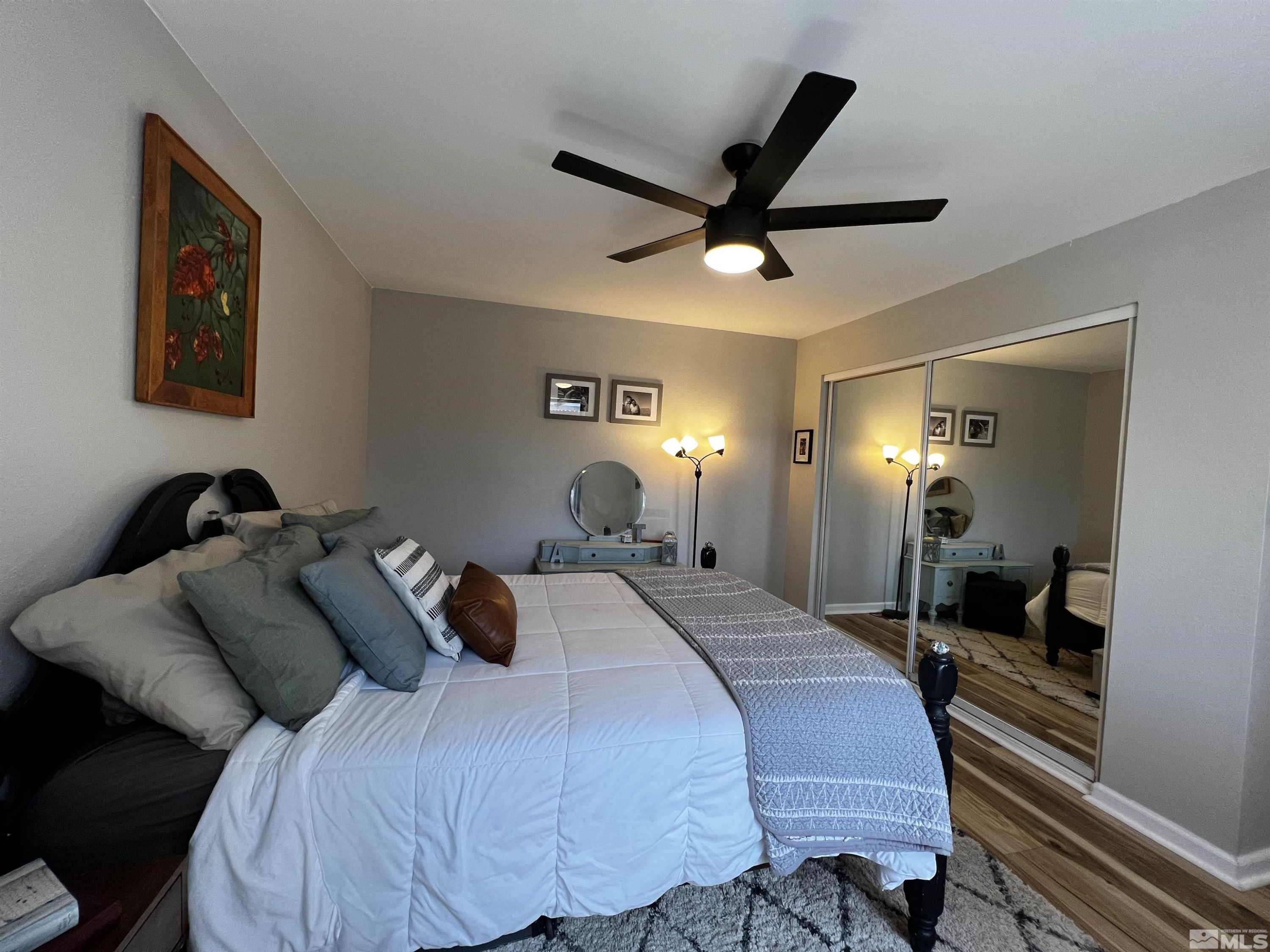 6412 Flower Street Reno, NV 89506 - Photo 23 of 38 a bedroom with a bed and a chandelier