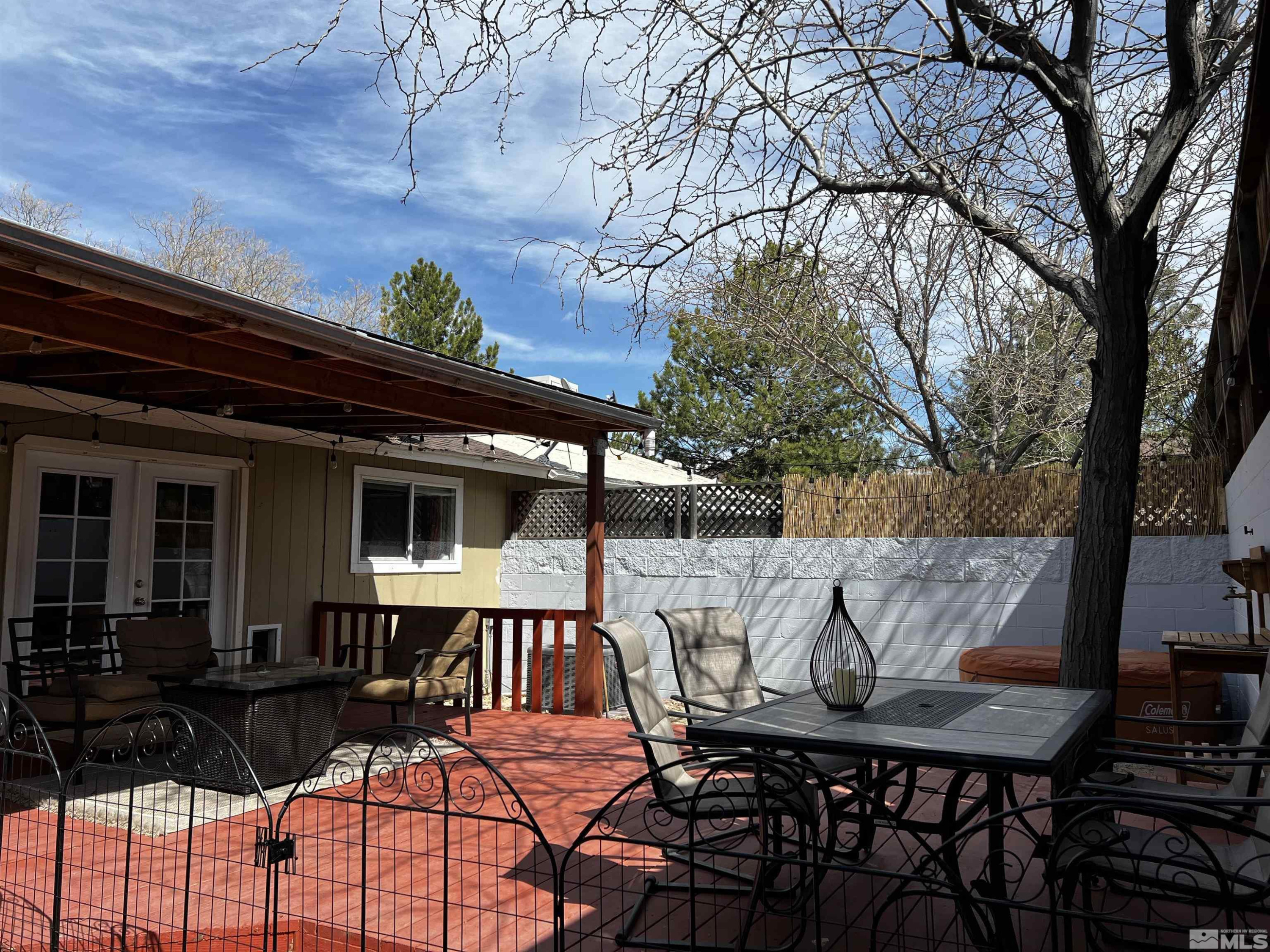 6412 Flower Street Reno, NV 89506 - Photo 32 of 38 a view of a patio with table and chairs with wooden floor and fence