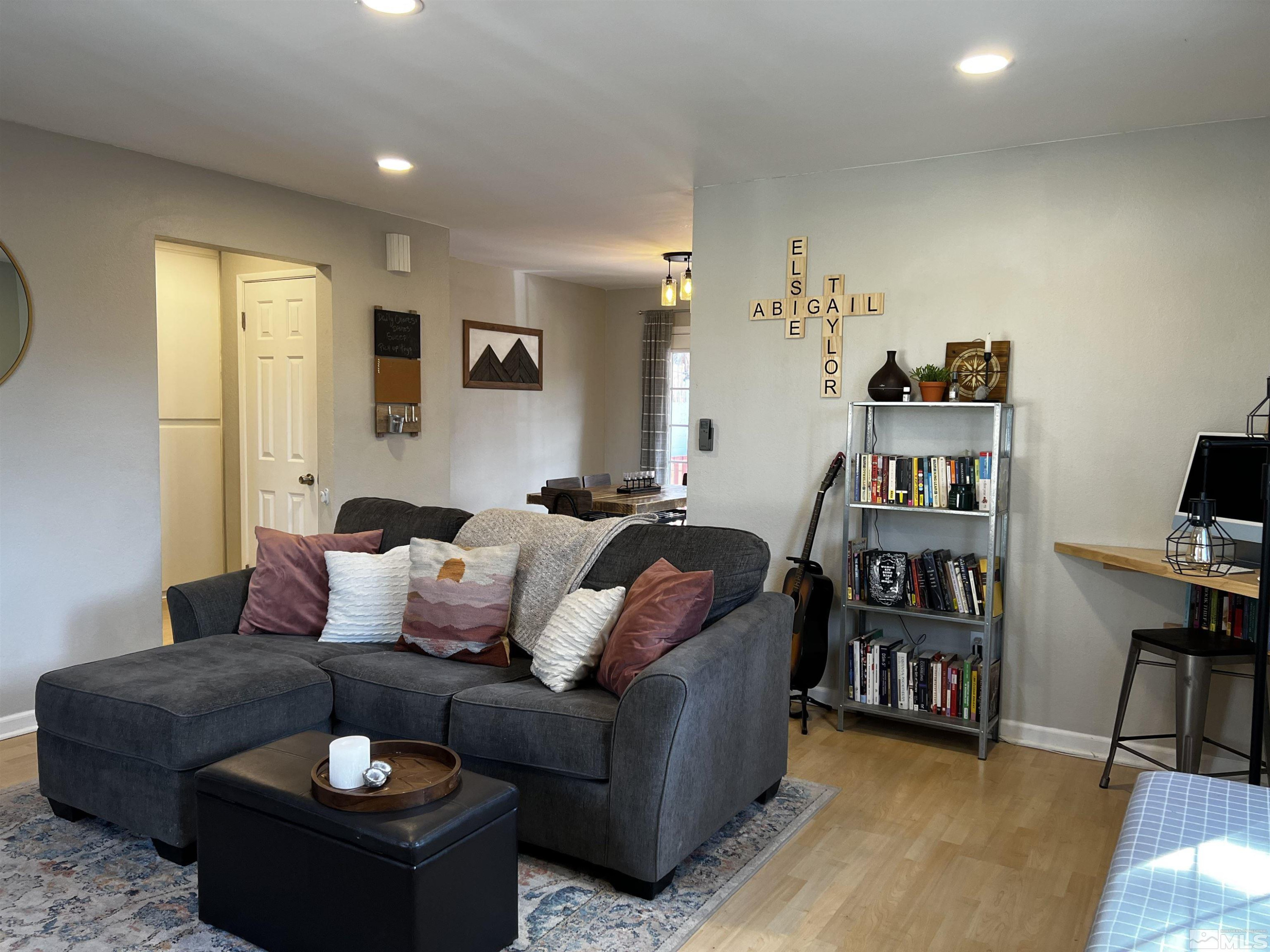6412 Flower Street Reno, NV 89506 - Photo 9 of 38 a living room with furniture and a book shelf