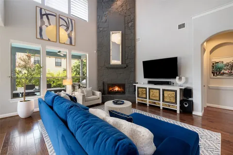 a living room with fireplace furniture and a flat screen tv