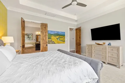 a bedroom with a bed and a flat screen tv