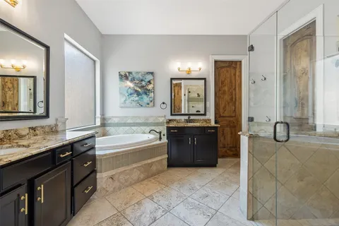 a bathroom with a tub sink and mirror