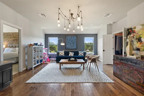 a living room with furniture and a chandelier