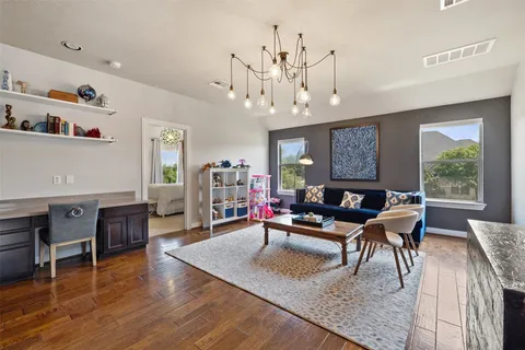 a living room with furniture dining table a window and a flat screen tv