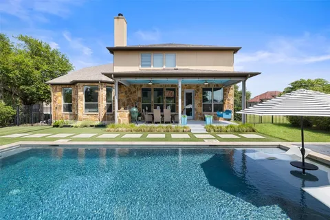 a view of a house with swimming pool and sitting area
