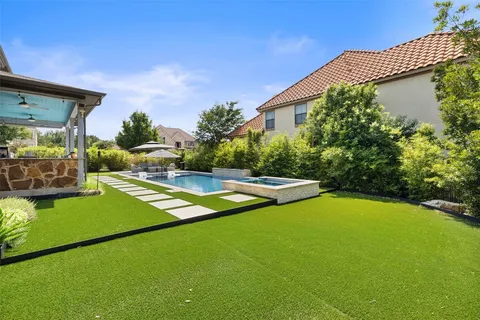 a view of a backyard with plants and a patio