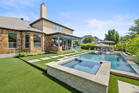 a view of a house with swimming pool and sitting area