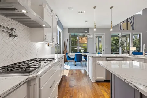 a kitchen with stainless steel appliances granite countertop a stove and a sink
